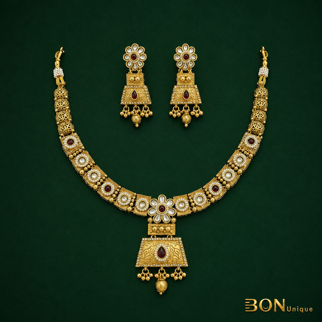 Close-up of antique gold kundan pendant with ruby stone and engraved scrollwork