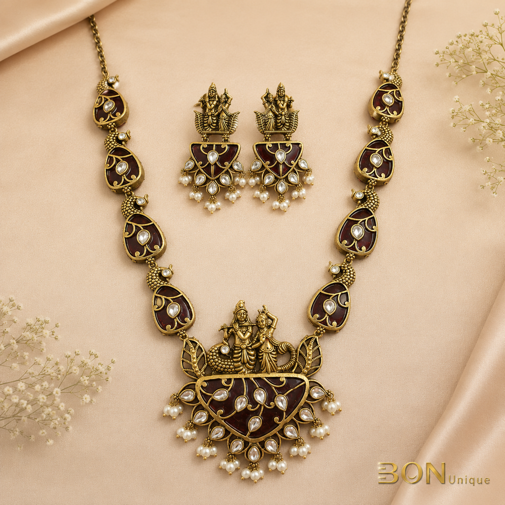 Full set view of antique gold Radha-Krishna temple necklace with maroon enamel chain links and matching earrings