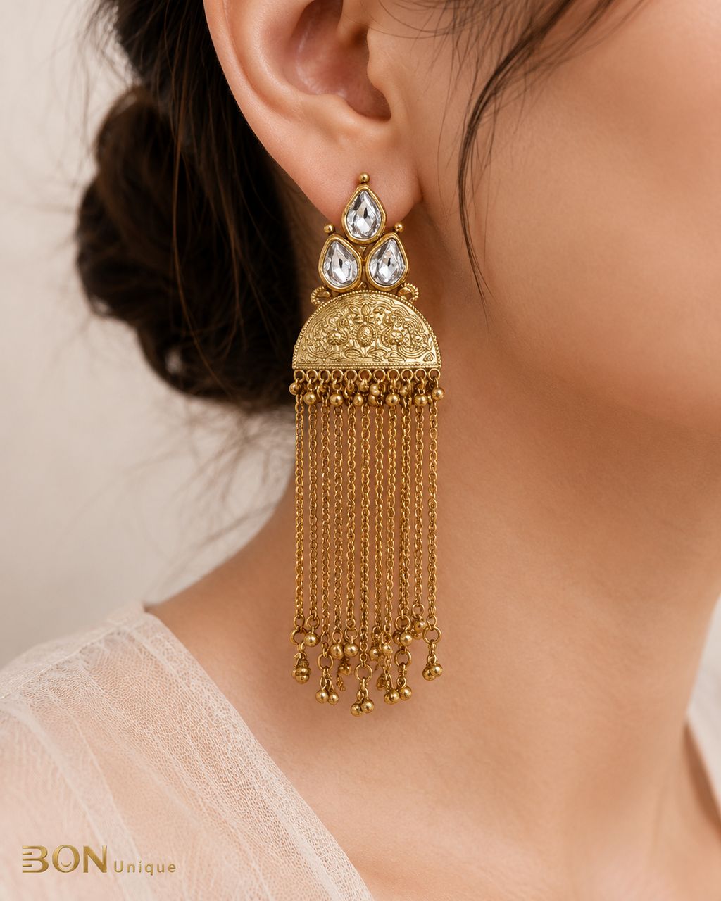 Model wearing Antique Gold Kundan Tassel Chain Earrings