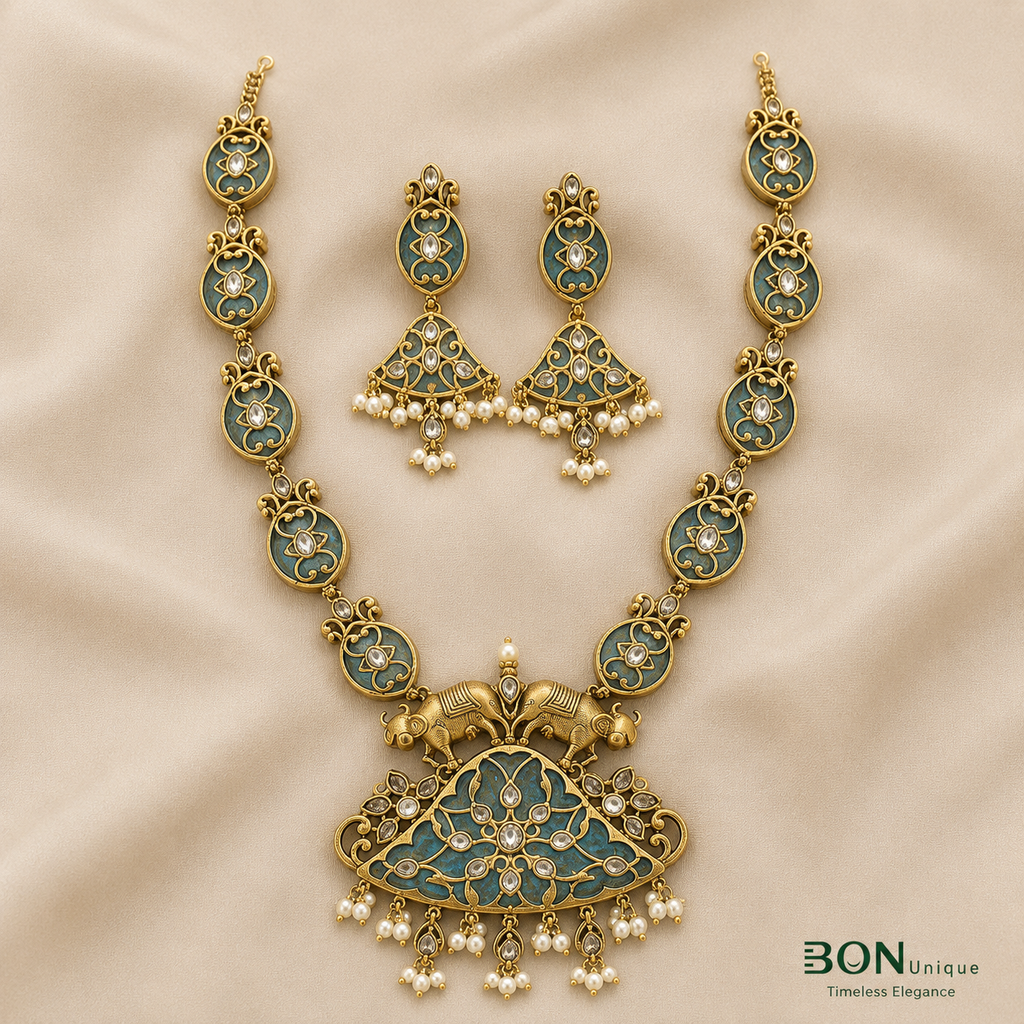 Full set view of antique gold dual elephant necklace with teal enamel chain and matching chandelier earrings